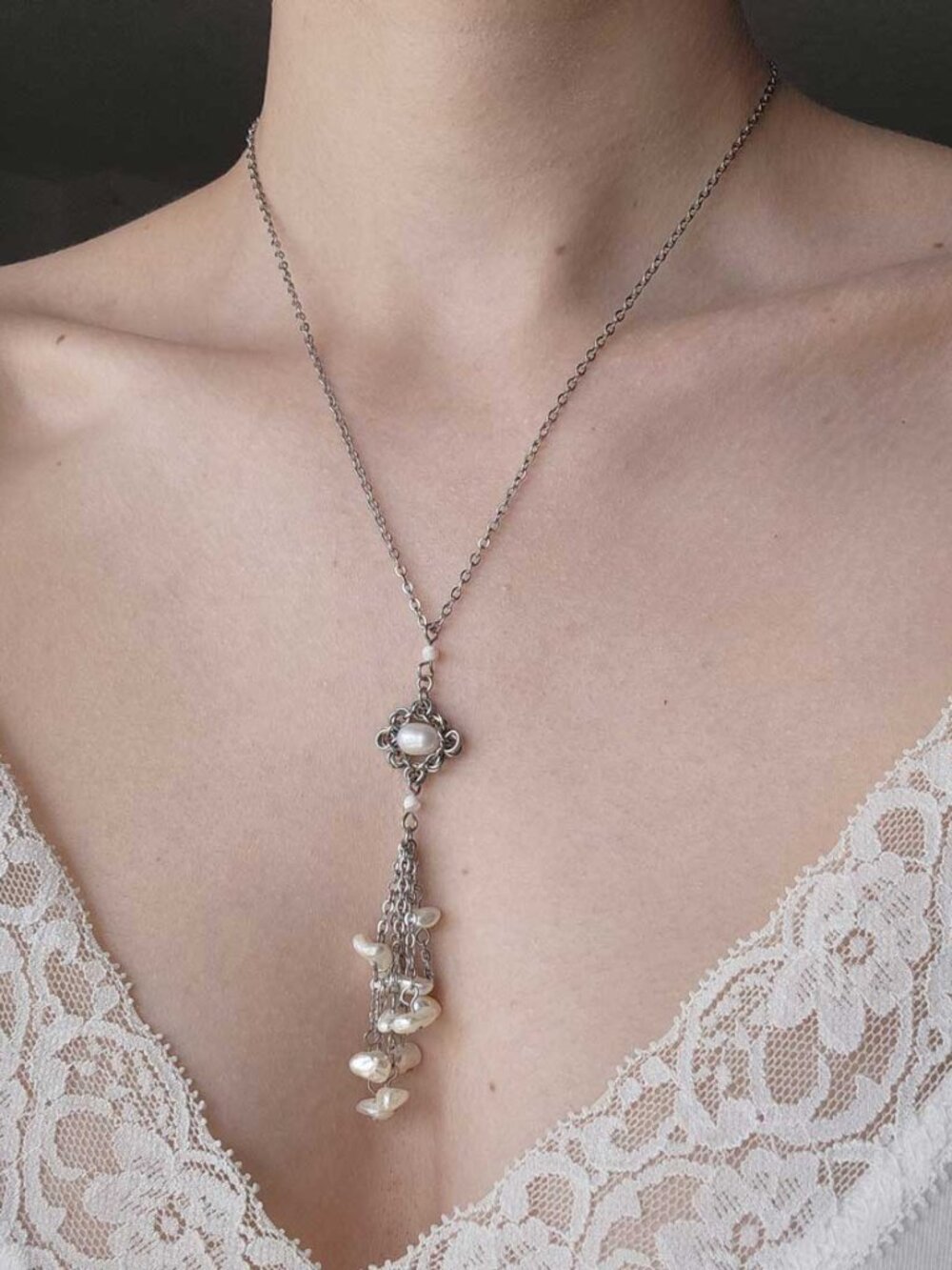 White pearl lariat necklace with a small silver chain